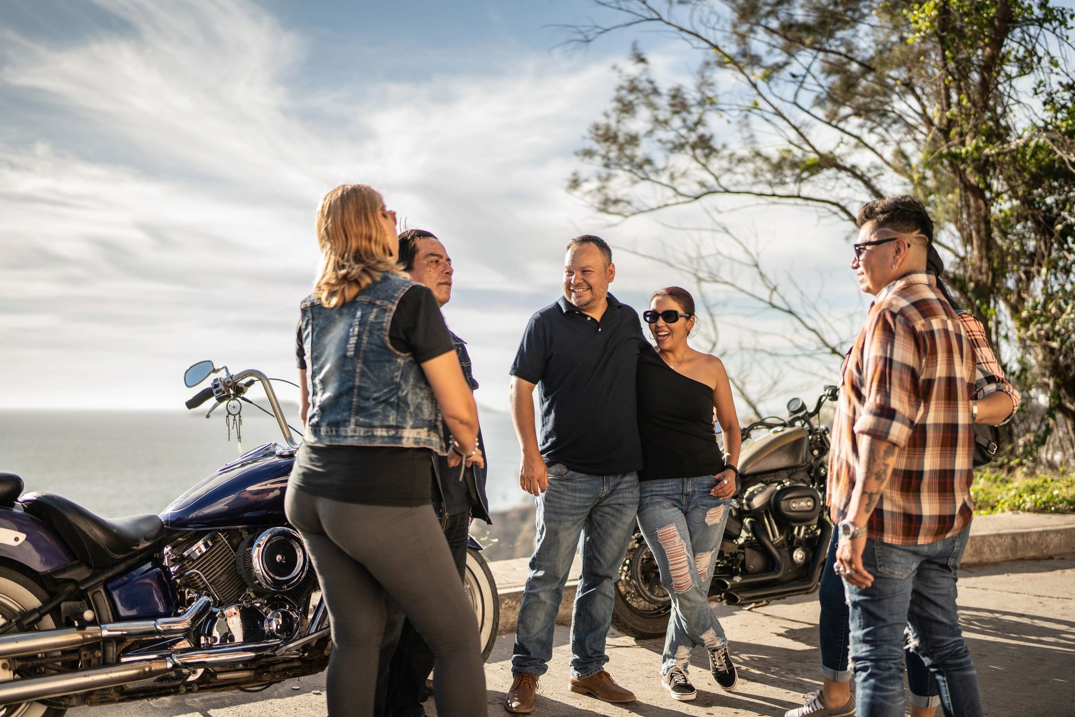 Riders talking during a motorcycle road trip stop